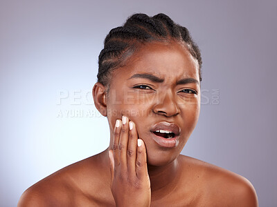 Buy stock photo Portrait, toothache and black woman with pain, dental hygiene or oral health on grey studio background. African person, face or model with emergency, frustrated or cavity crisis with sensitive teeth