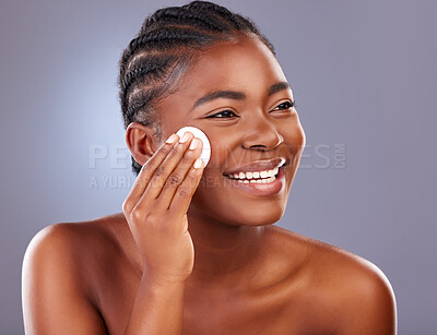 Buy stock photo Black woman, cosmetics and beauty with cotton pad, product and happy for results with cleanser. African, female person and smile for skincare, pride and glow for dermatology in gray background
