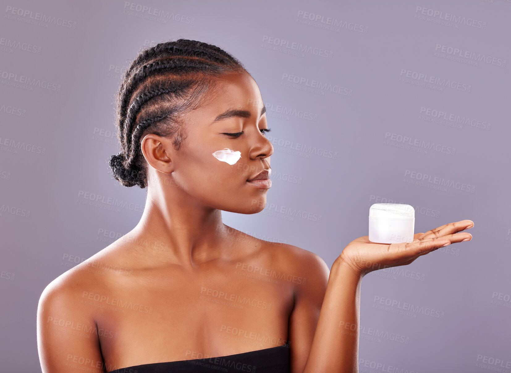 Buy stock photo Black woman, cosmetics and beauty with moisturizer, product and cream for results in studio backdrop. African, female person and smile for skincare, pride and glow for dermatology in gray background
