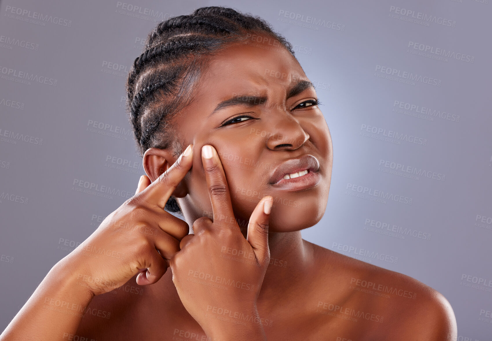 Buy stock photo Black woman, portrait and squeezing pimple or blemish in studio with unhappy for cosmetics. African, female person and frown for skincare, results in dermatology for beauty on gray background
