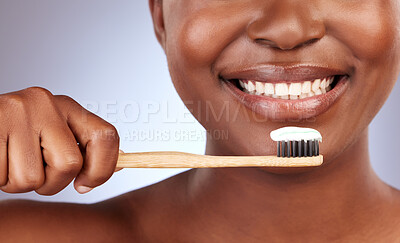 Buy stock photo Toothpaste, smile and woman with bamboo toothbrush in studio with oral care and hygiene routine. Happy, closeup and female person clean teeth for dental treatment with fresh breath by gray background