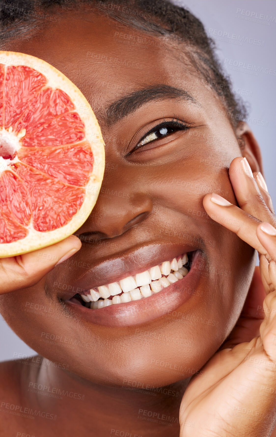 Buy stock photo Black woman, skincare and beauty with grapefruit, product and happy with organic cleanser or results. African, female person and smile for cosmetics, pride or glow for dermatology in gray background
