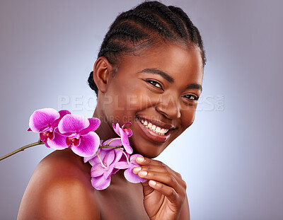 Buy stock photo Beauty, flower and portrait of black woman in studio with natural, health and facial routine. Skincare, wellness and African model with orchid plant for dermatology face treatment by gray background.