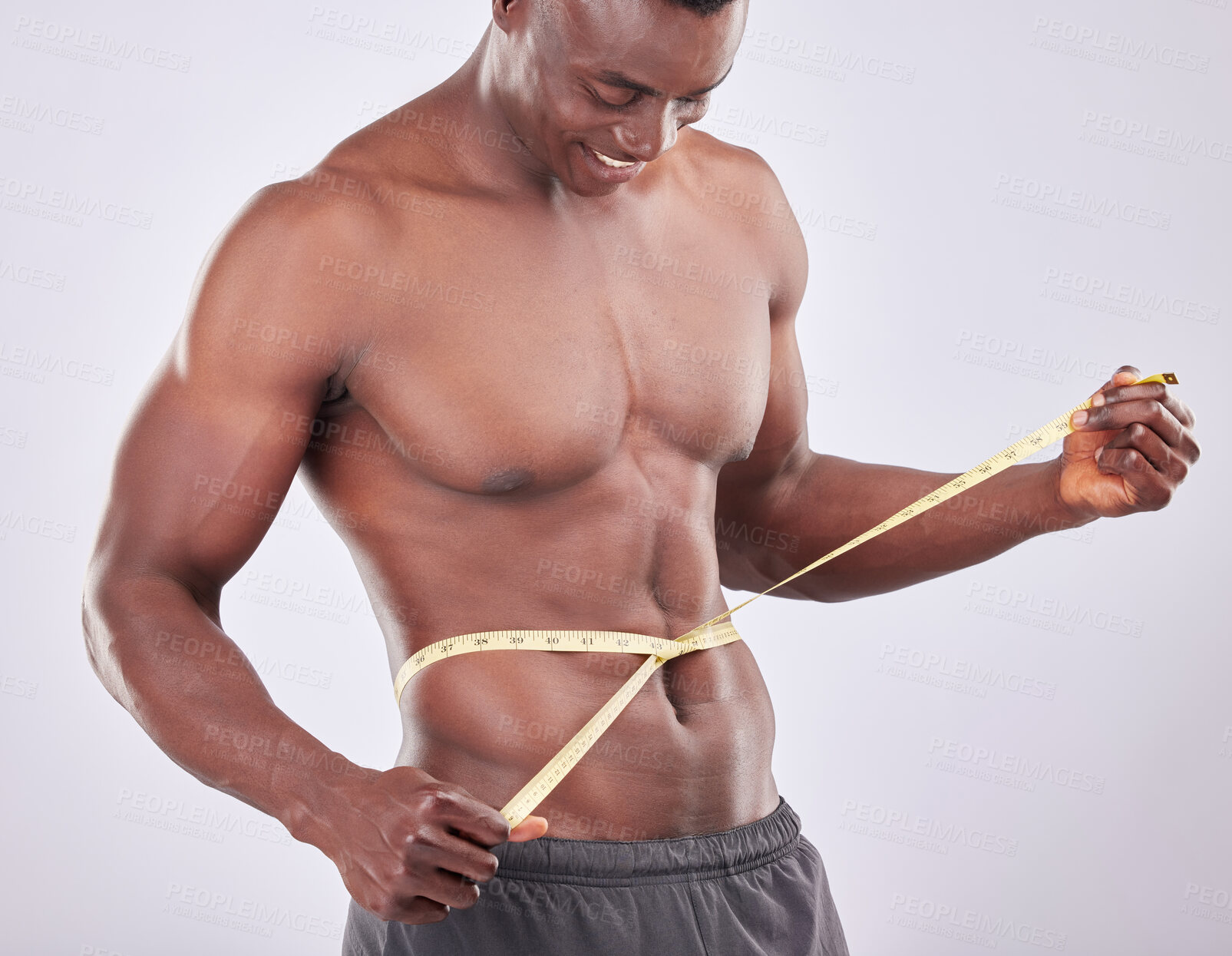 Buy stock photo Stomach, waist and black man with tape measure for fitness, weight loss goals and training in studio. African person, strong body and check exercise results for health by white background muscle