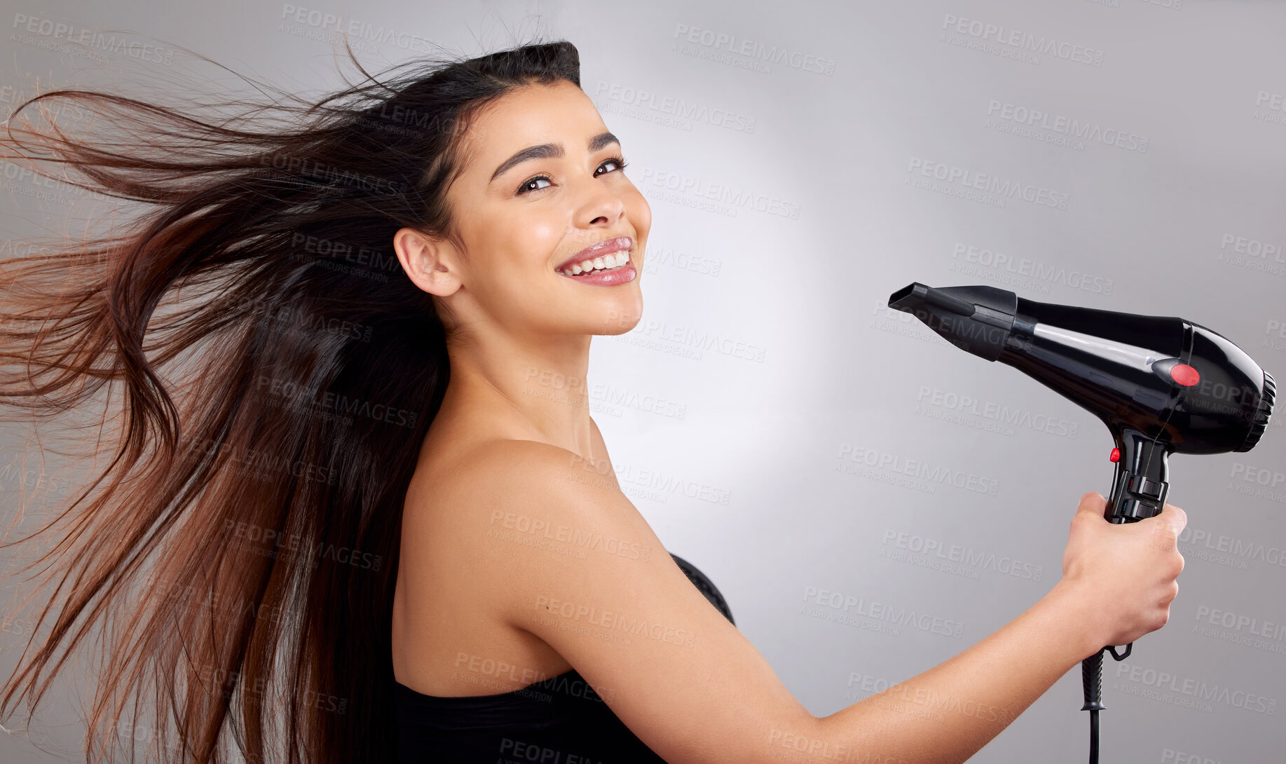 Buy stock photo Portrait, happy woman and hairdryer in studio for beauty, wellness and cosmetics. Model girl, smile or face and wind for salon treatment, glow and shine with results for hair by white background