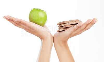 Buy stock photo Hands, decision and apple or chocolate in studio with choice for healthy snack, nutrition benefits and balance diet. Person, food and fruit for breakfast, challenge and wellness on white background