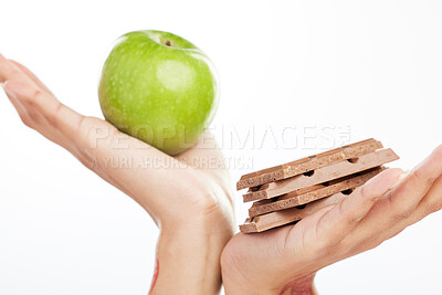 Buy stock photo Decision, hands and apple or chocolate in studio with choice for healthy snack, nutrition benefits and balance diet. Person, food and fruit for breakfast, challenge and wellness on white background