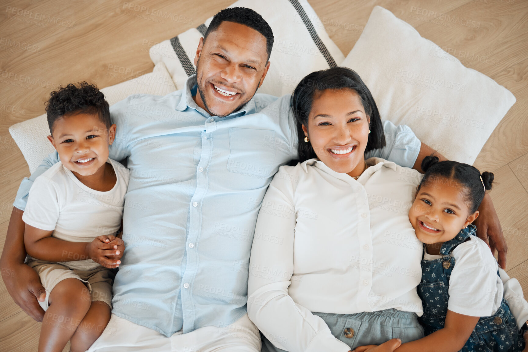 Buy stock photo Shot of a family laying on the floor at home