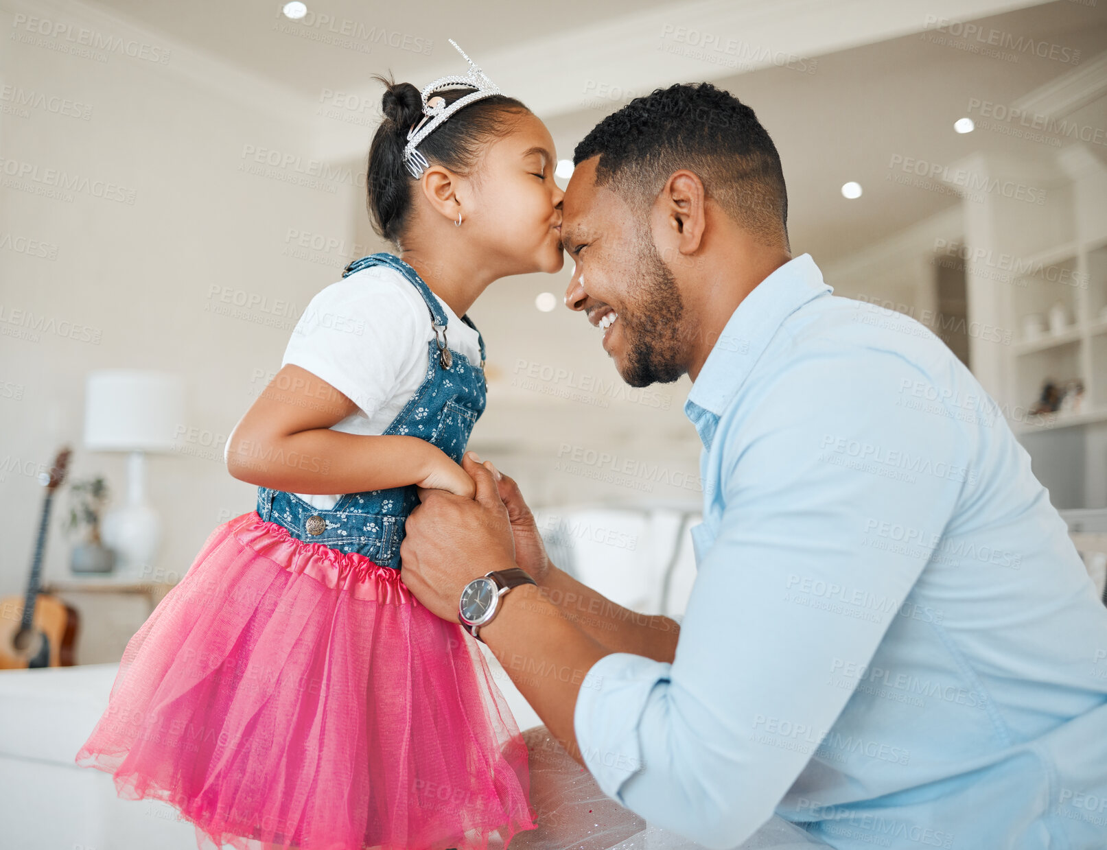 Buy stock photo Shot of a little girl giving her dad a kiss at home
