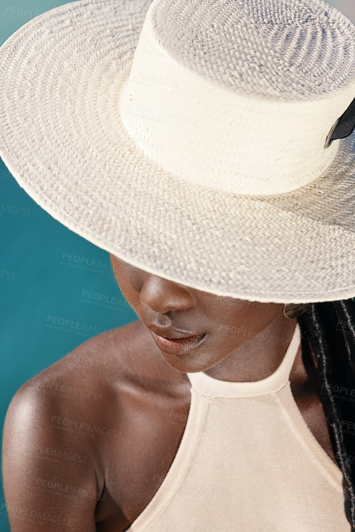 Buy stock photo Fashion, hat and black woman in studio, mystery and think of elegance on blue background. Trendy, accessory and African person with cover for aesthetic, minimal style and chic with reflection
