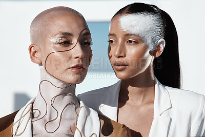 Buy stock photo Closeup shot of two beautiful young women showing off unconventional make-up looks