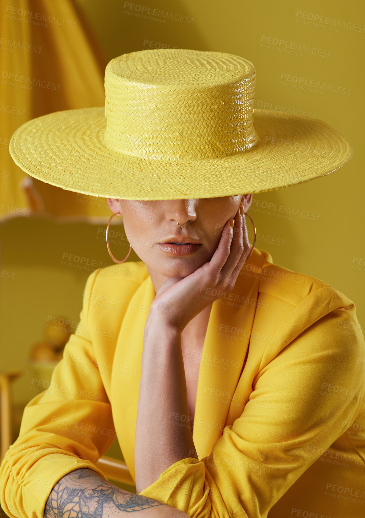 Buy stock photo Studio shot of a young woman dressed in stylish yellow clothes against a yellow background