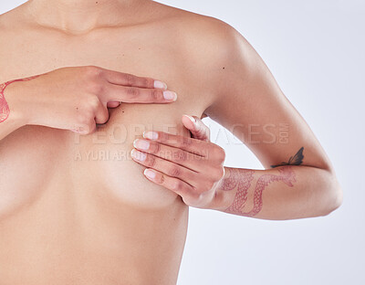 Buy stock photo Studio shot of an unrecognizable woman examining her breast