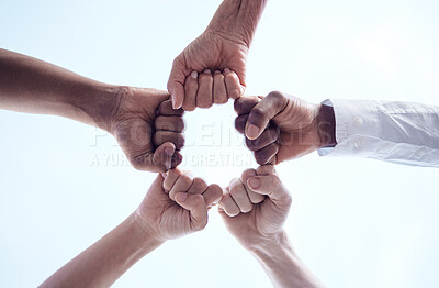 Buy stock photo Cropped shot of a group of unrecognizable businesspeople joining their fists together