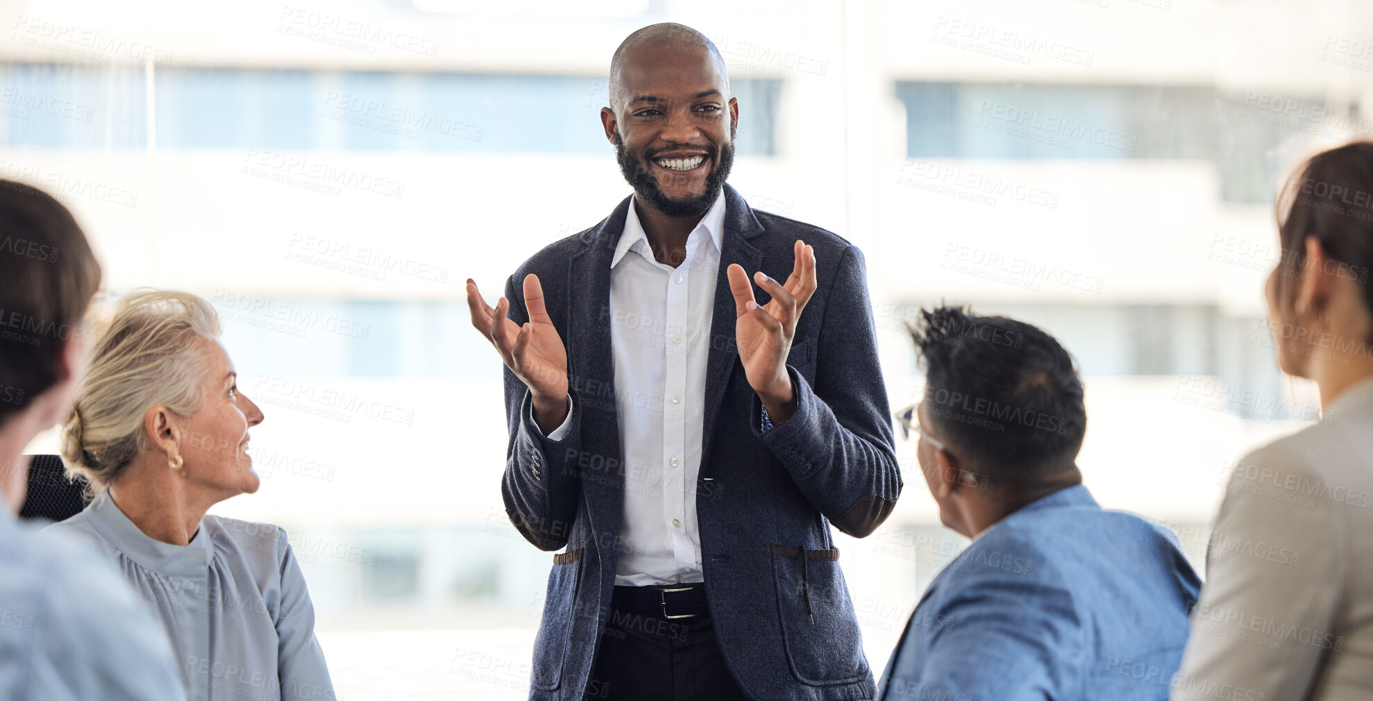 Buy stock photo Shot of a young businessman having a meeting with his colleagues in an office