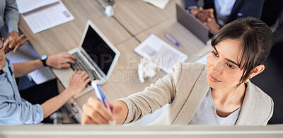 Buy stock photo High angle shot of a young businesswoman writing notes on a whiteboard during a presentation in an office