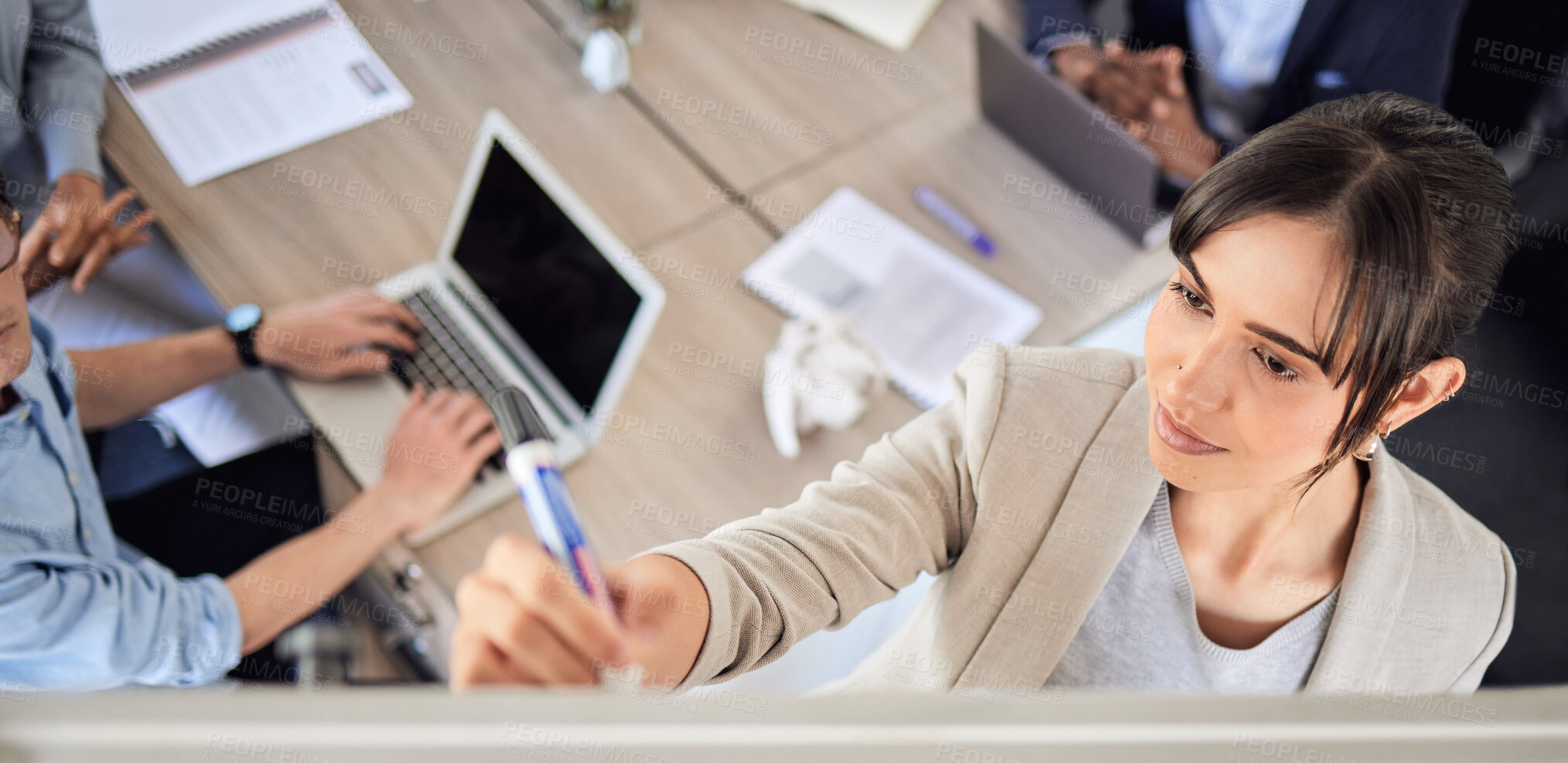 Buy stock photo High angle shot of a young businesswoman writing notes on a whiteboard during a presentation in an office