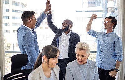 Buy stock photo Shot of a group of businesspeople cheering in an office