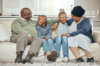 Buy stock photo Shot of grandparents bonding with their grandkids on a sofa at home
