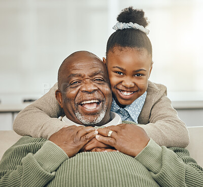 Buy stock photo Shot of a grandfather bonding with his young granddaughter on a sofa at home