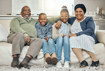 Buy stock photo Shot of grandparents bonding with their grandkids on a sofa at home
