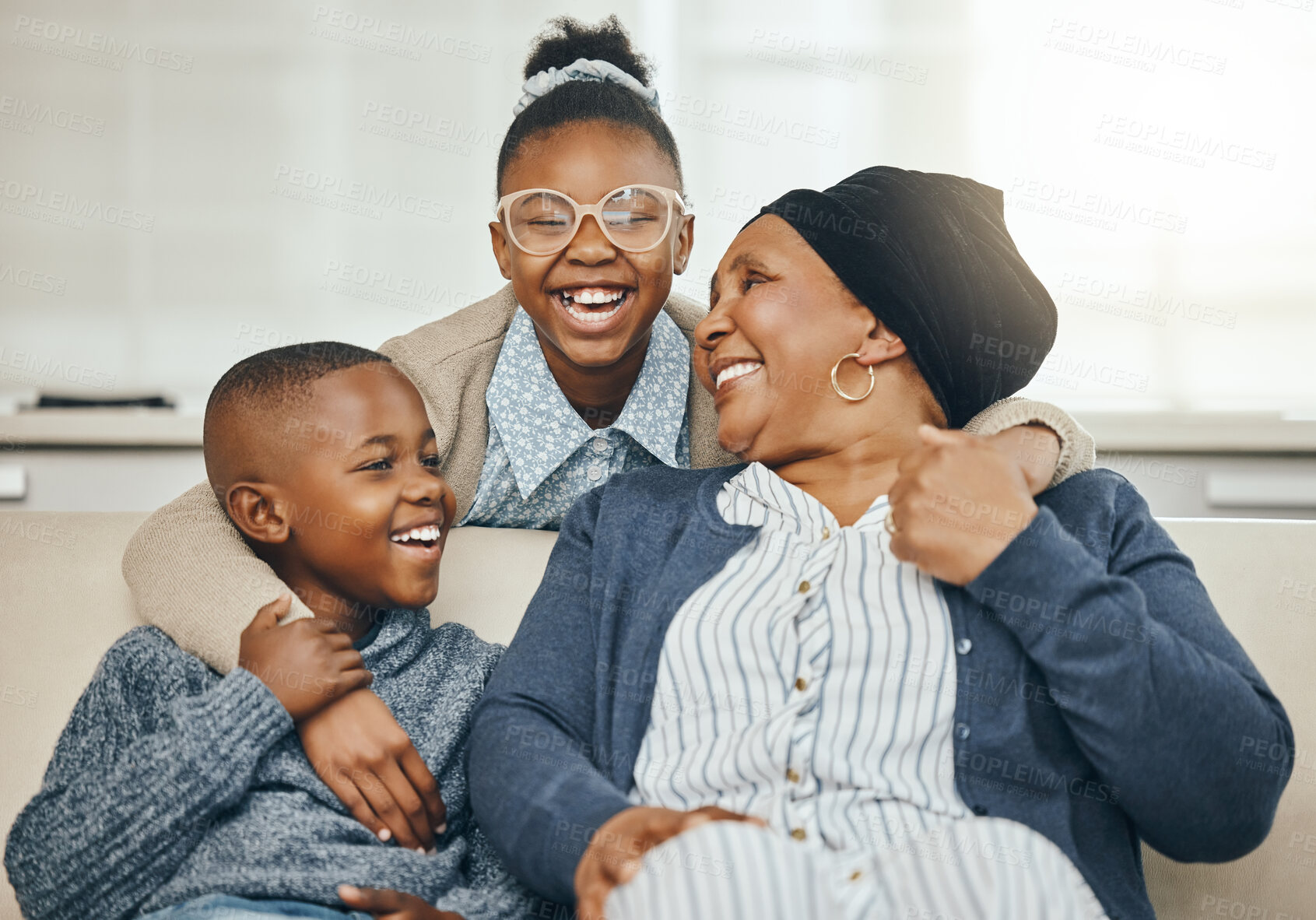 Buy stock photo Shot of a grandmother bonding with her grandkids on a sofa at home