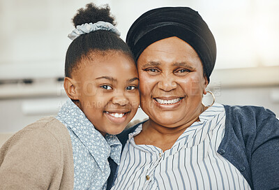 Buy stock photo Shot of a grandmother bonding with her granddaughter on a sofa at home