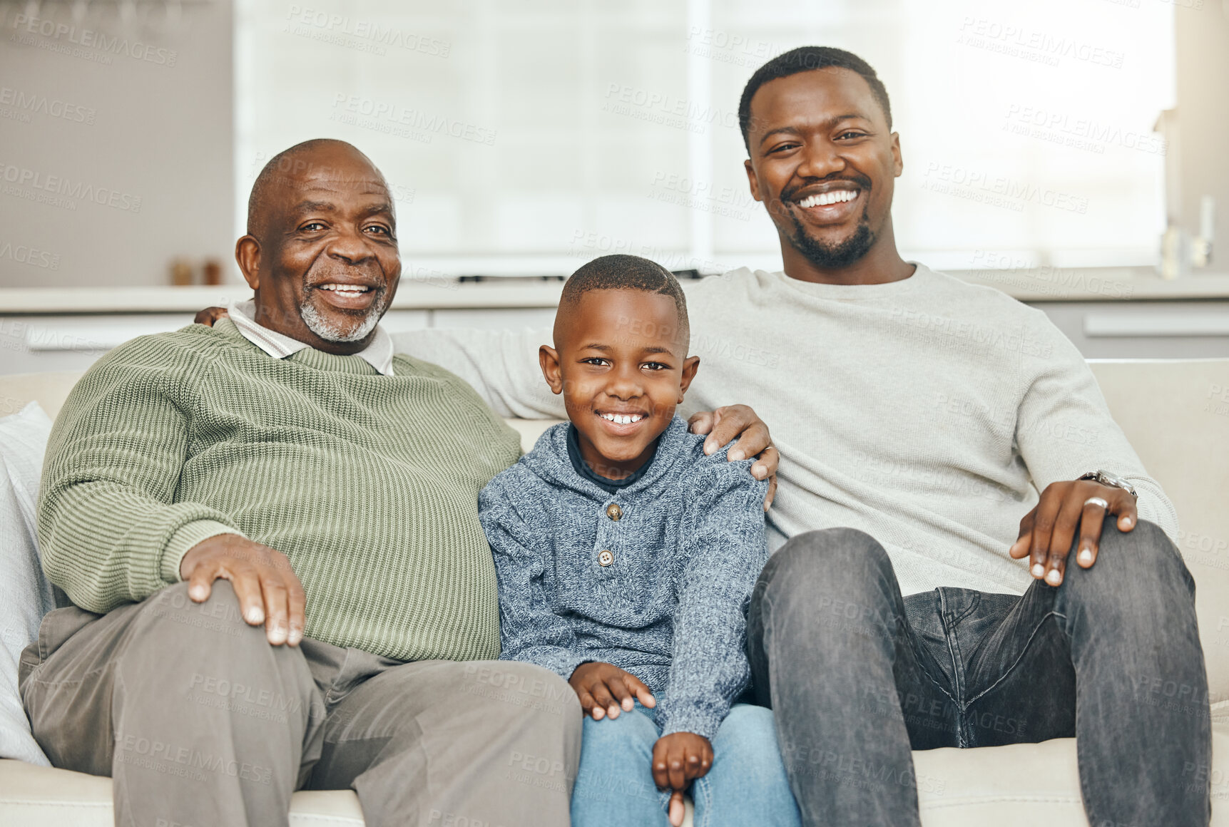 Buy stock photo Shot of a grandparent bonding with his son and grandson on a sofa at home