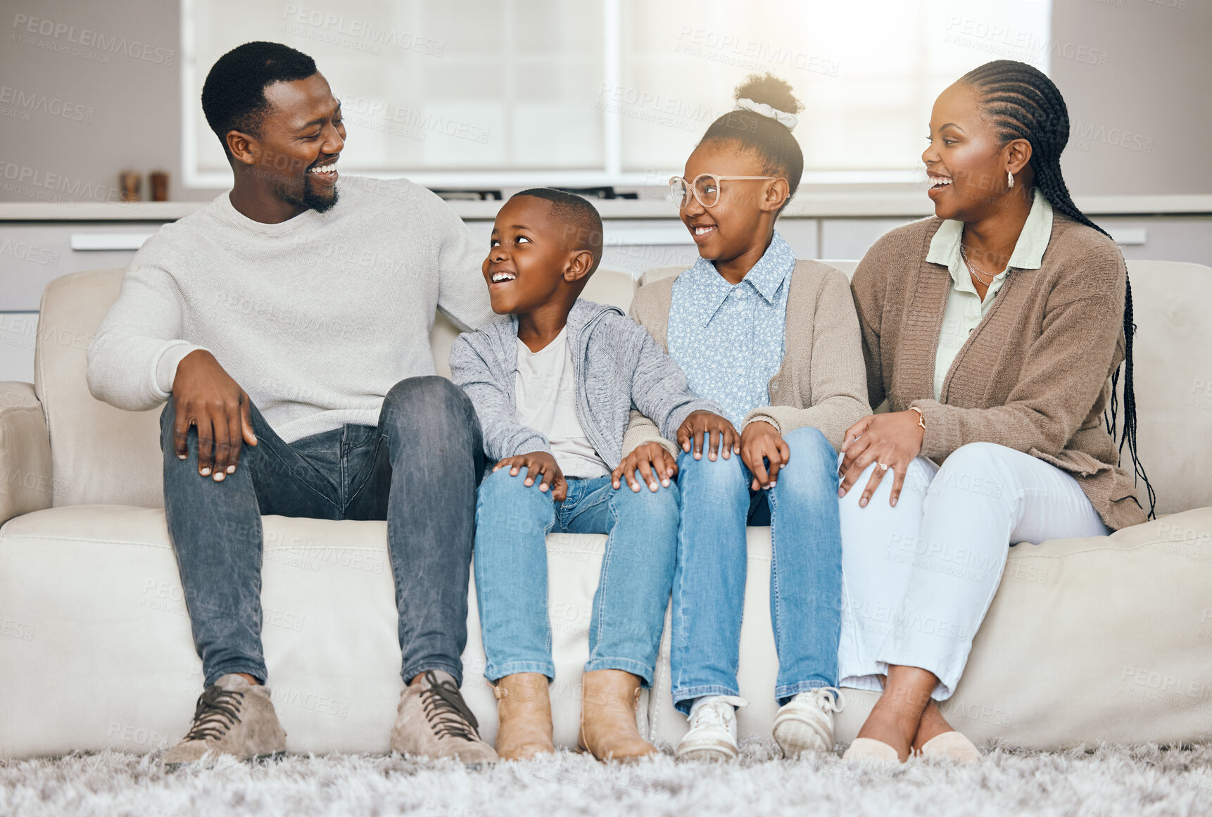 Buy stock photo Home, funny and black family on couch, smile and cheerful with joke, bonding together and fun. African people, parents and mother with father, kids and children with happiness or laughing in lounge