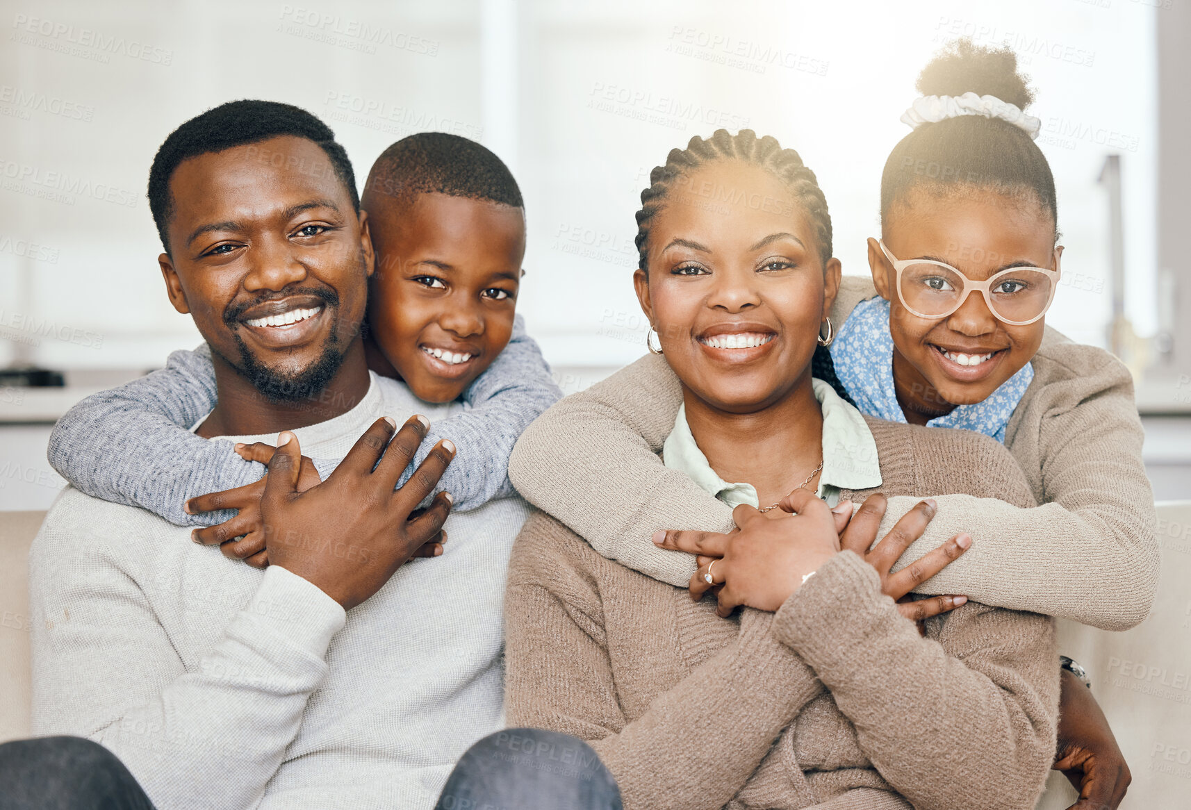 Buy stock photo Portrait, black family and hug with love on sofa for weekend bonding, relax together and peace of childhood comfort. Happy, parents and children with embrace for security, relationship care and house