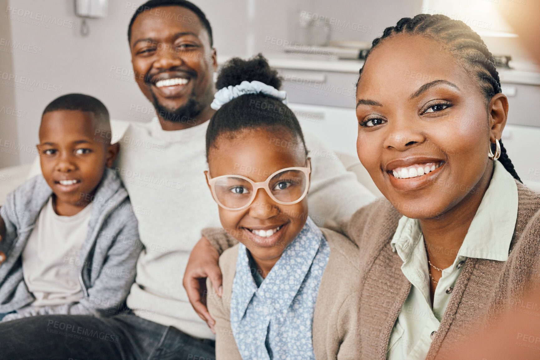 Buy stock photo Shot of a young family taking a selfie together at home