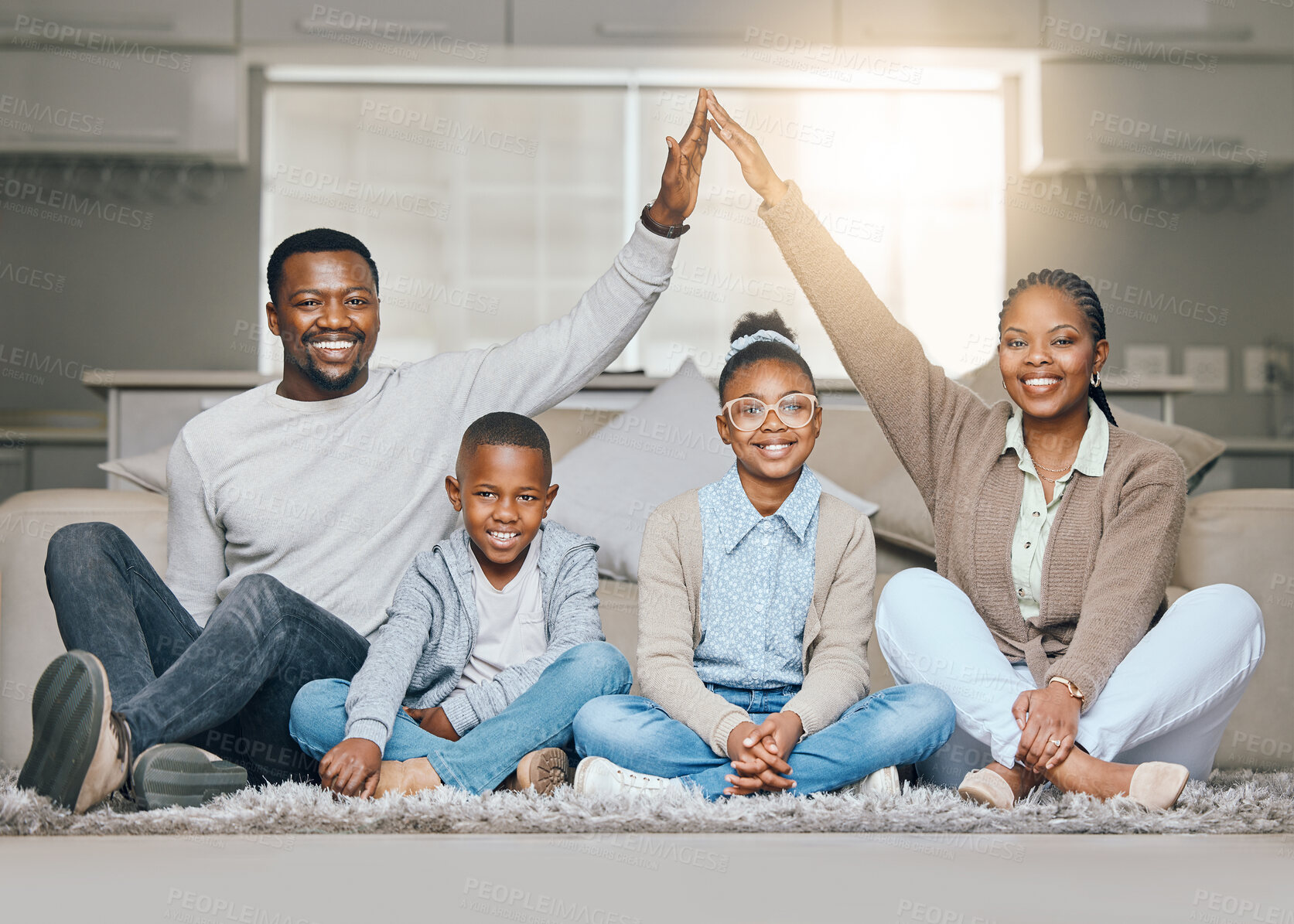 Buy stock photo Shot of a young family relaxing together at home