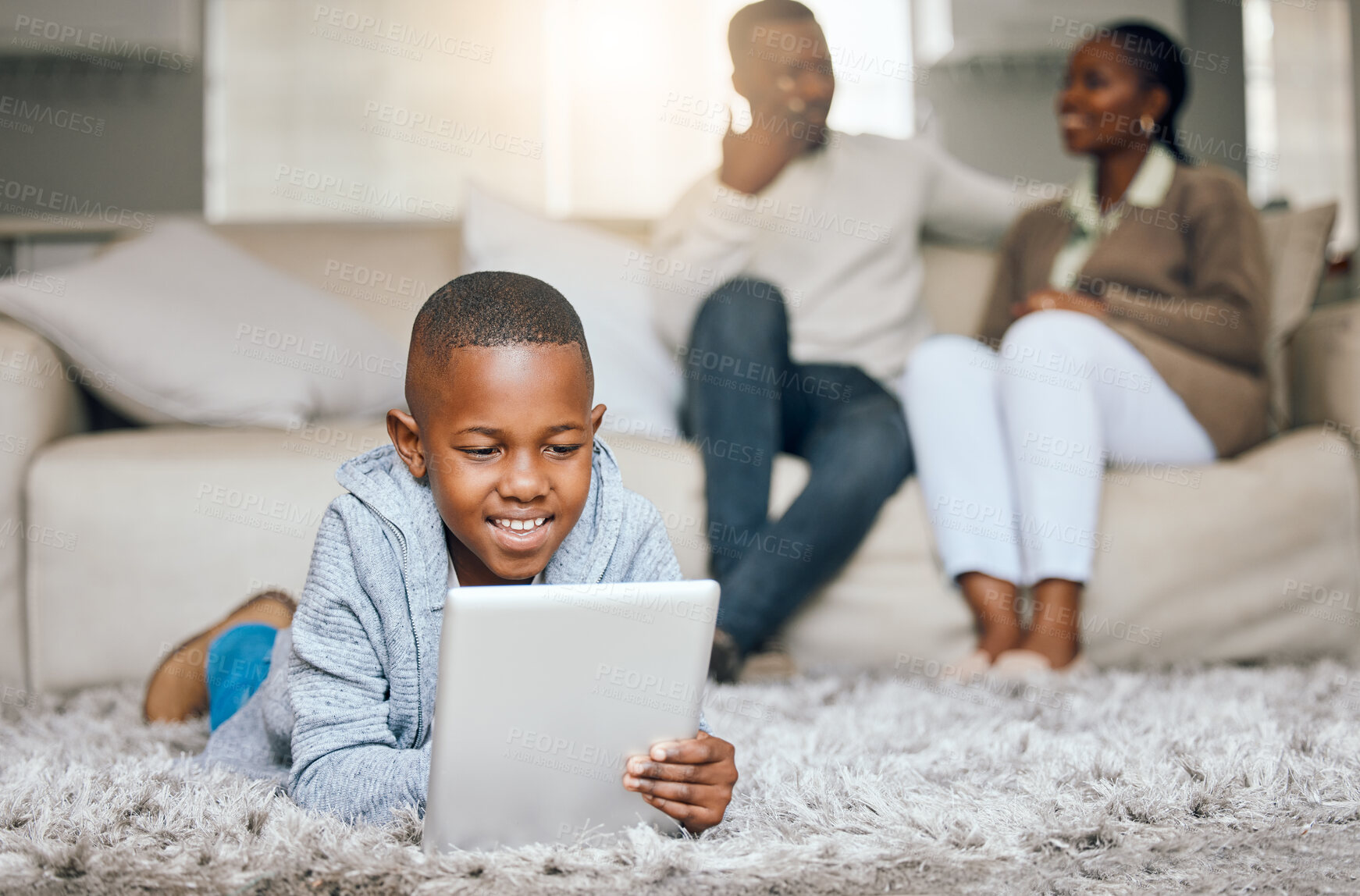 Buy stock photo Shot of a little boy using a digital tablet at home