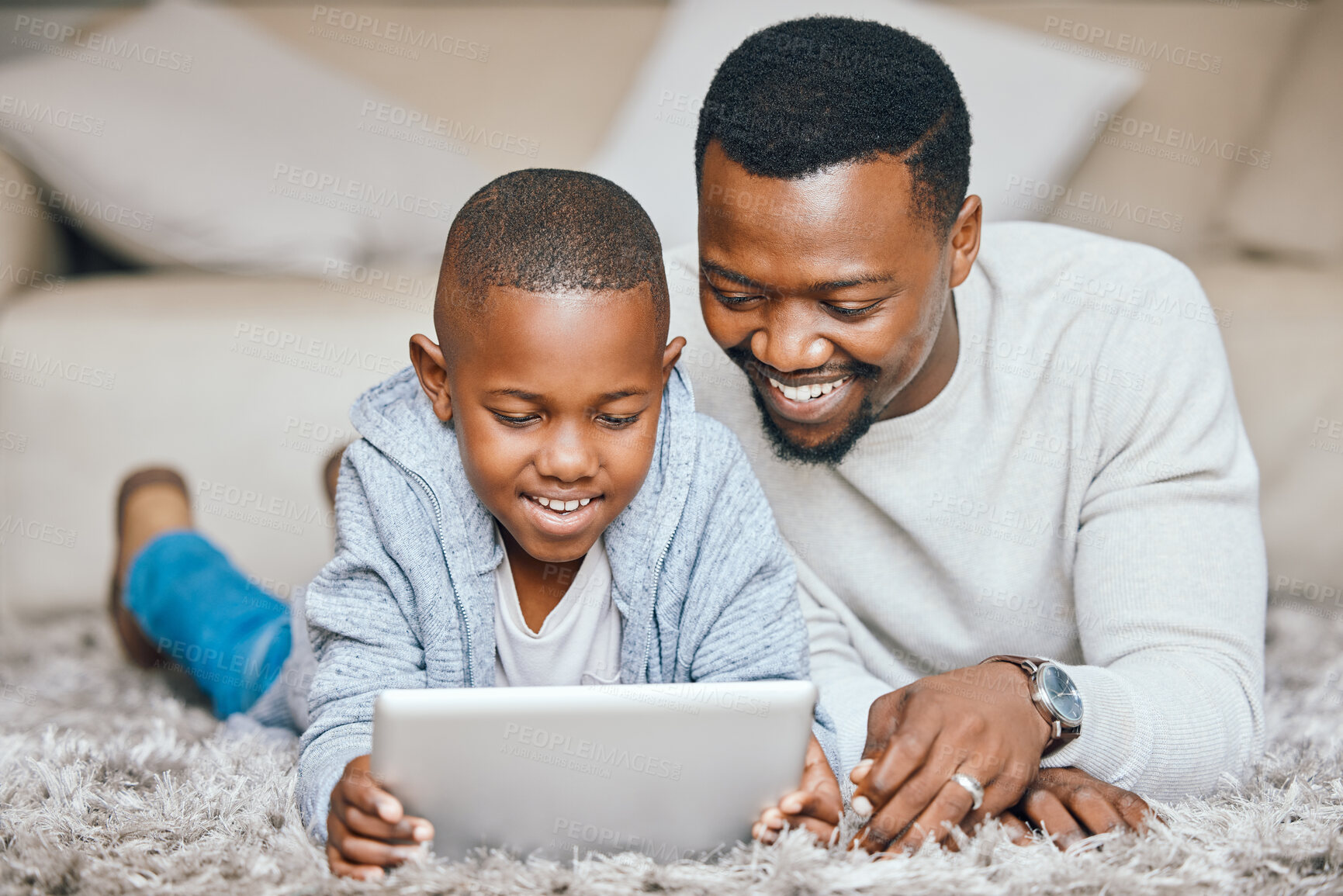 Buy stock photo Black man, child and tablet at house for streaming, education games and watch video of learning support. Father, boy and digital for reading ebook, language development and storytelling website