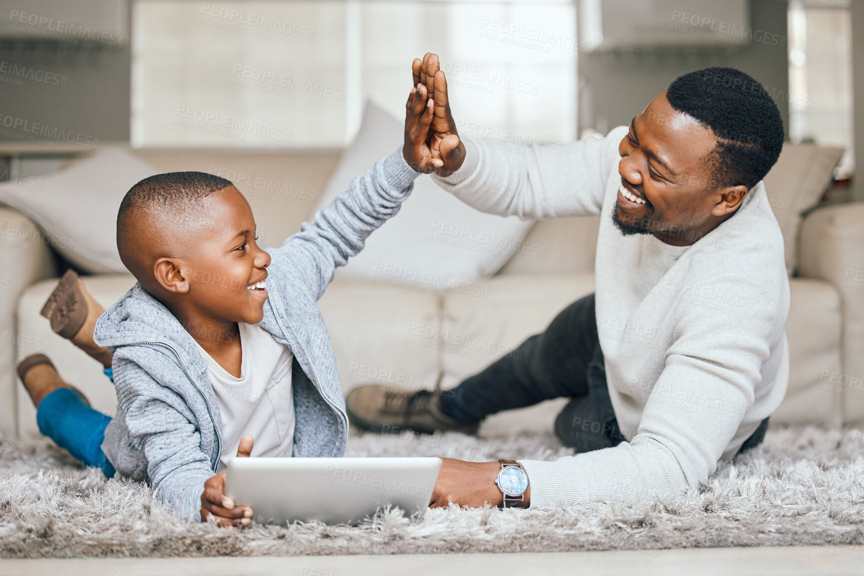 Buy stock photo Black family, child and tablet with high five at house for streaming, education success and celebration of learning. Father, boy and digital for reading ebook, study achievement and bonding support