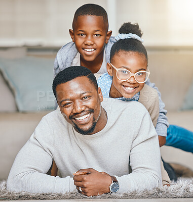 Buy stock photo Shot of a young father and his children relaxing together at home