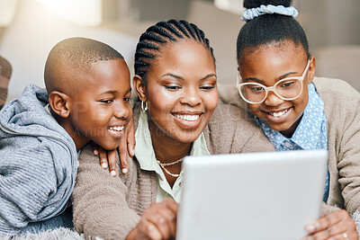 Buy stock photo Shot of a mother using a digital tablet with her children at home
