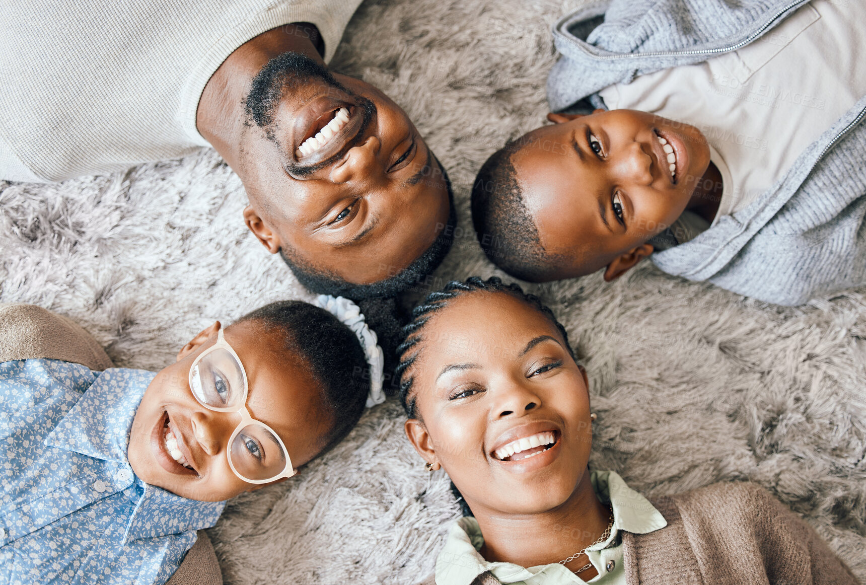 Buy stock photo Black family, portrait and relax in home with top view for bonding, support and relationship on weekend. Parents, children and comfortable as people in apartment for connection, love and leisure