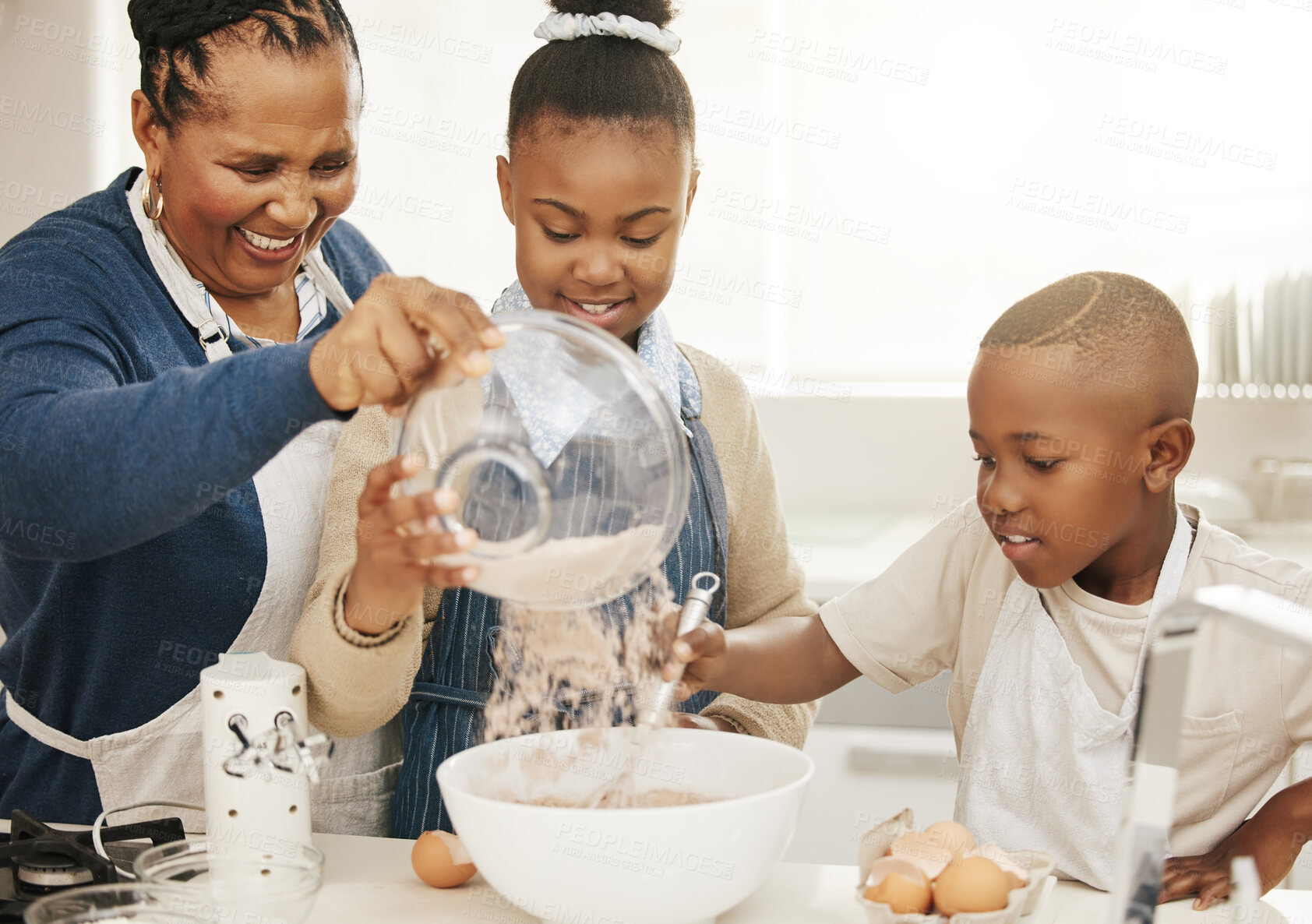 Buy stock photo Black family, grandma teaching kids baking and learning baker skill in kitchen with help and support. Old woman with girl and boy are happy, development with growth and bake with ingredients at home