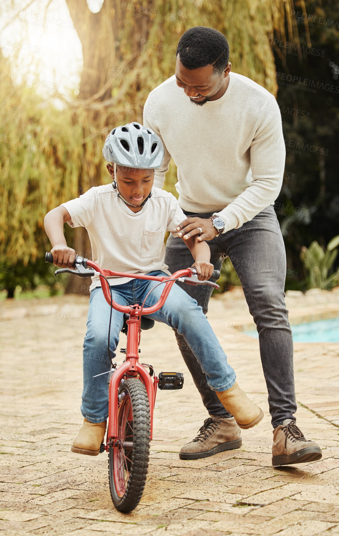 Buy stock photo Father, son and teaching with bicycle or helmet for safety, protection or learning to ride bike in nature. Happy black man, dad or little boy with cycling lesson, practice or training in neighborhood