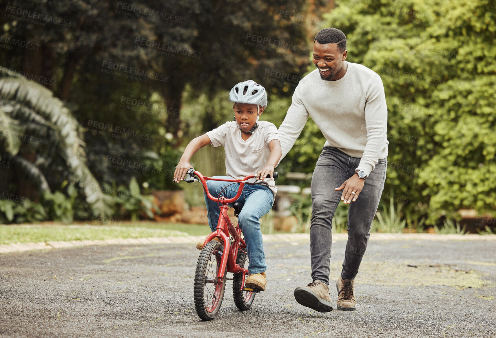 Buy stock photo Black family, father teaching child cycling in park with bicycle and helmet for safety, learning and help. Support, motivation and trust, man with boy outdoor and learn bike riding with mockup space