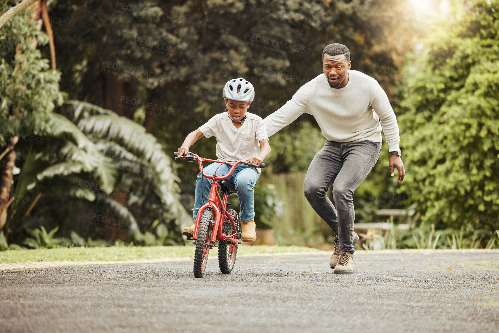 Buy stock photo Family, father teaching child cycling in park with bicycle and helmet for safety, learning and help. Support, motivation and trust, black man with boy outdoor and learn bike riding with mockup space