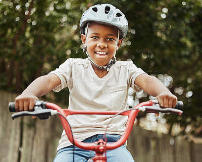 Buy stock photo Shot of a little boy riding his bicycle outside