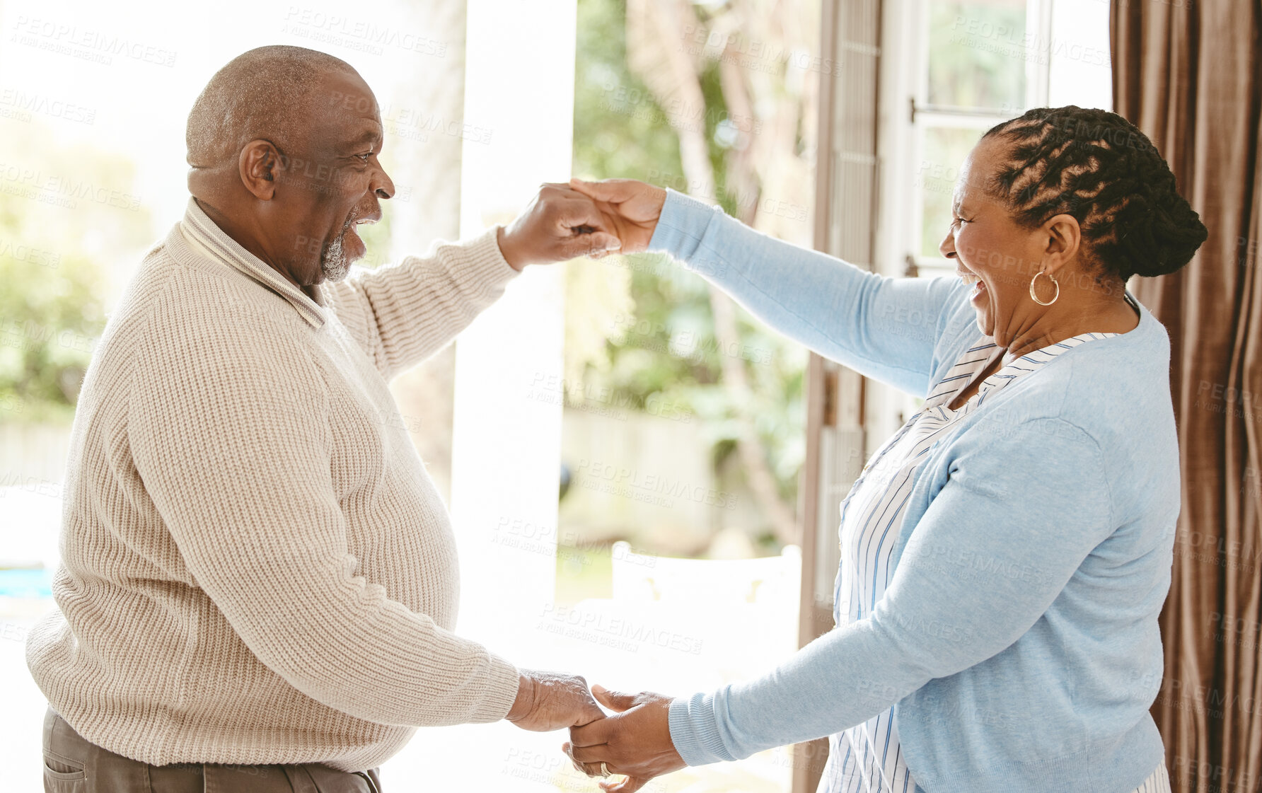 Buy stock photo Black couple, retirement and happy in home for dance, love and trust in relationship. Elderly woman, husband and holding hands for care with bonding, fun and excited for milestone with celebration