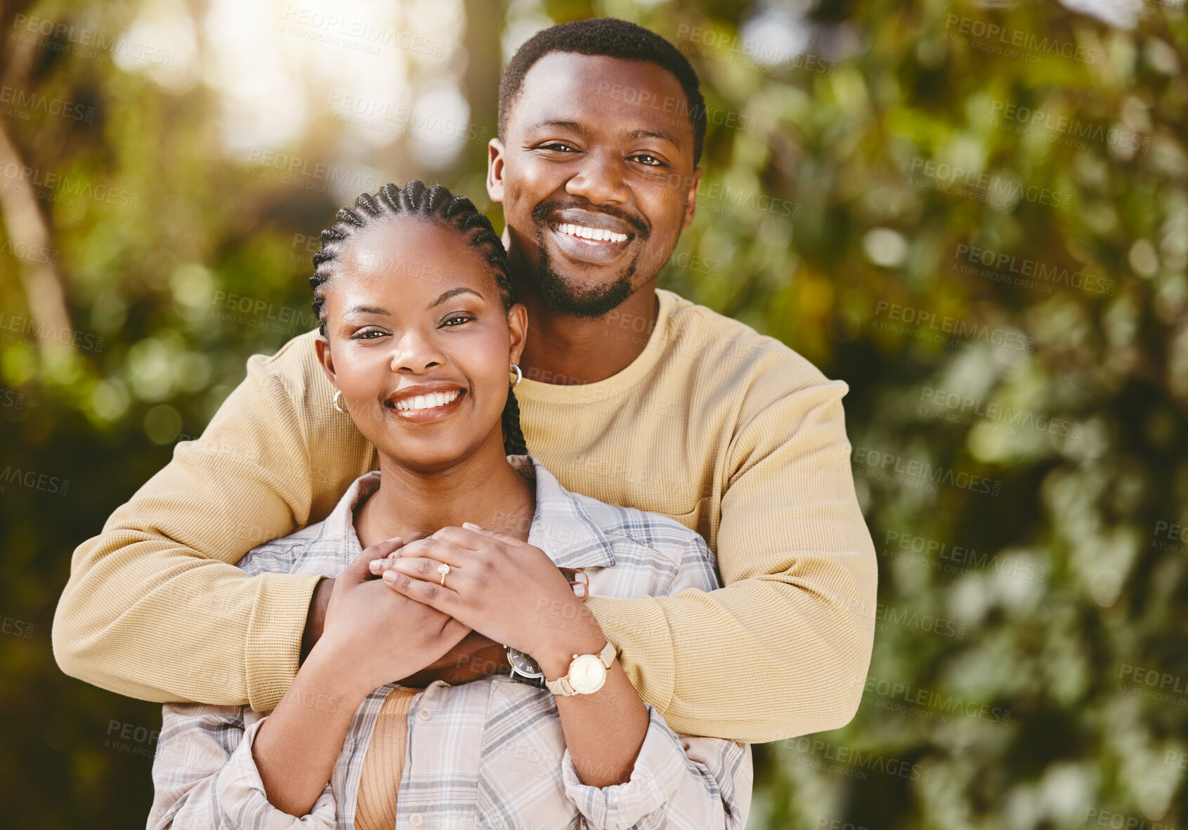 Buy stock photo Black couple, portrait and hug in nature for love, care and relationship with partner, security and bonding. Man, woman and happy for embrace, support and trust with commitment, smile and romance