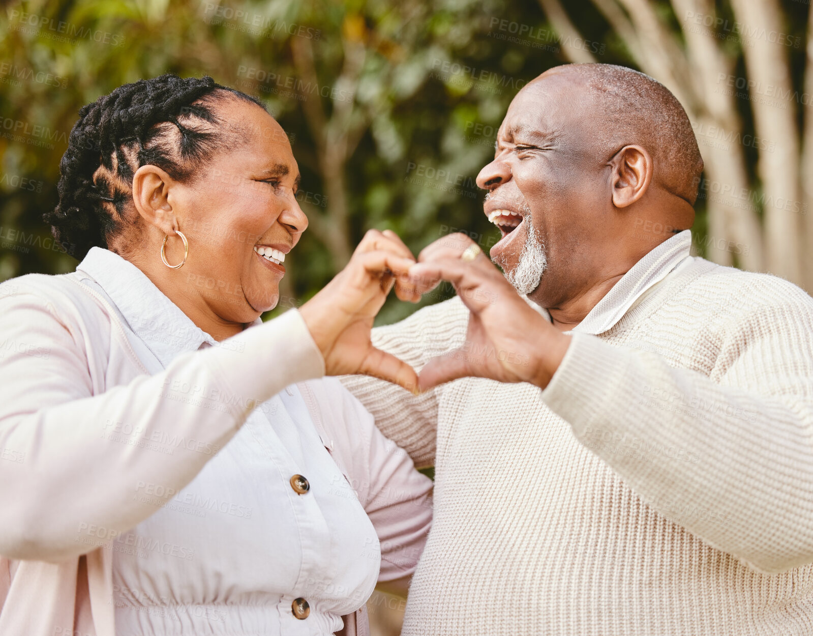 Buy stock photo Heart, hands and senior couple outdoor for romance, affection and commitment in marriage with laughing. African people, love emoji and loyalty gesture in nature for caring and trust in relationship