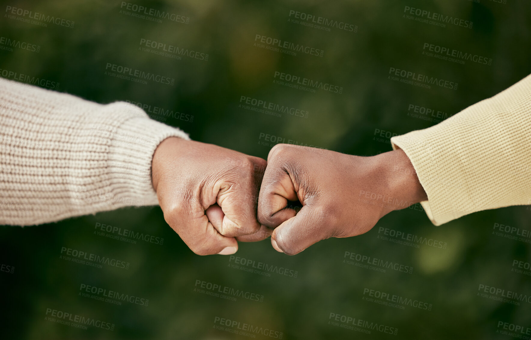Buy stock photo Shot of two unrecognizable men bumping fists outside