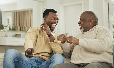 Buy stock photo Shot of a father and son laughing in the lounge