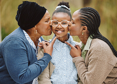 Buy stock photo Cropped portrait of an adorable little girl being kissed on the cheeks by her mother and grandmother