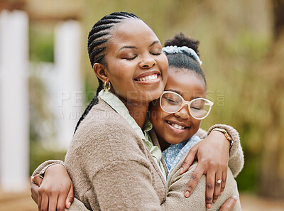 Buy stock photo Cropped shot of an attractive young woman and her daughter embracing outdoors